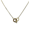 Gold necklace with a small pendant on a light gray background