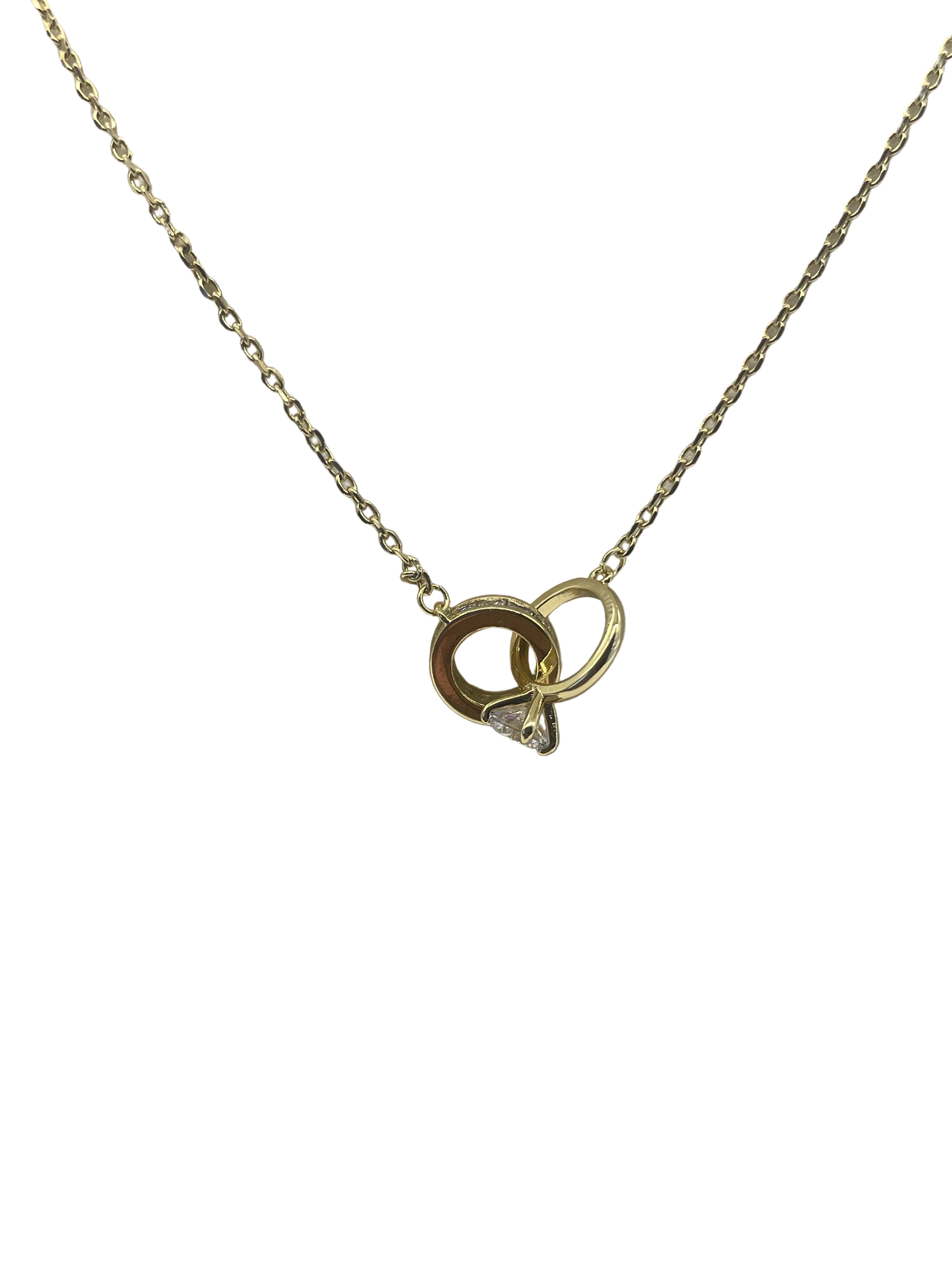 Gold necklace with a small pendant on a light gray background