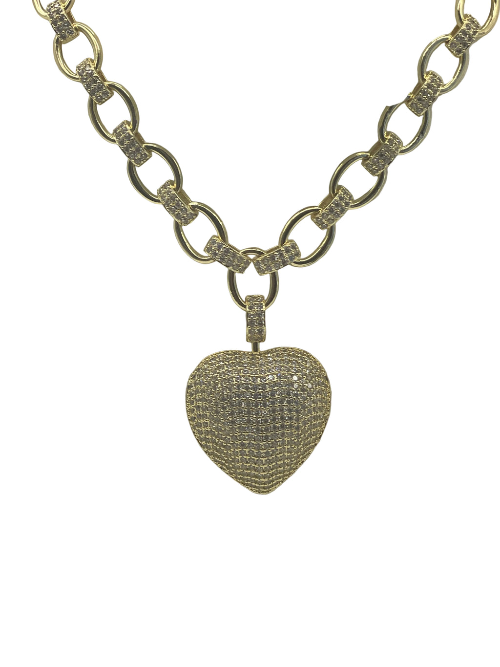 Gold chain necklace with a heart-shaped, diamond-studded pendant on a white background