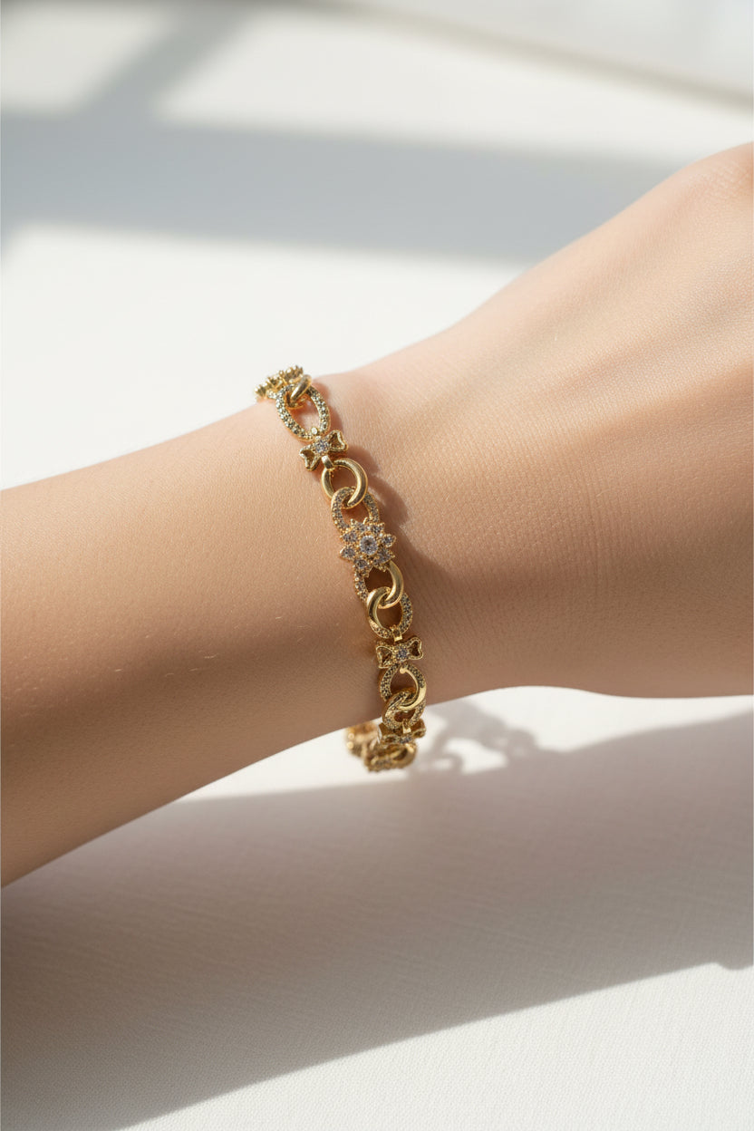 Gold bracelet on a wrist with a light background